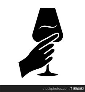Hand holding glass of wine glyph icon. Glassful of alcohol beverage. Wine service. Glassware. Celebration, party. Toast. Cheers. Silhouette symbol. Negative space. Vector isolated illustration