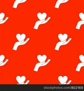 Hand holding heart pattern repeat seamless in orange color for any design. Vector geometric illustration. Hand holding heart pattern seamless