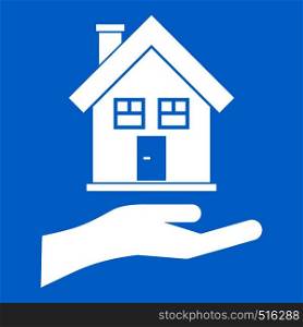 Hand holding house icon white isolated on blue background vector illustration. Hand holding house icon white