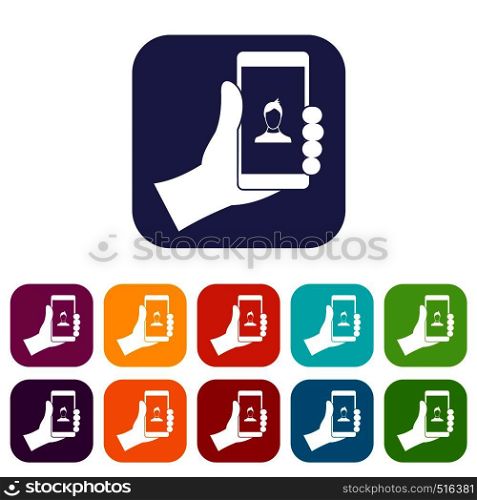 Hand holding smartphone with photo icons set vector illustration in flat style in colors red, blue, green, and other. Hand holding smartphone with photo icons set