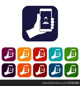 Hand holding smartphone with photo icons set vector illustration in flat style in colors red, blue, green, and other. Hand holding smartphone with photo icons set