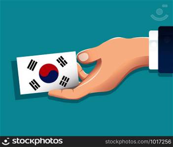 hand holding South Korea flag card with blue background. vector illustration eps10