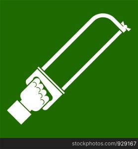 Hand holding spatula tool icon white isolated on green background. Vector illustration. Hand holding spatula tool icon green