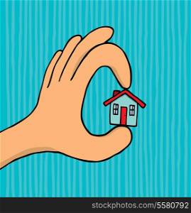 Hand holding tiny house
