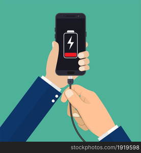 Hand holds a phone with a low battery charge. Mobile phone with USB connection. Vector illustration in flat style. Hand holds a phone with a low battery charge.