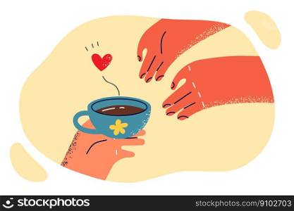 Hand passes freshly brewed coffee to another person as romantic gesture or courtship during love relationship. Cup of hot coffee with heart as metaphor for romantic present for loved one. Hand passes freshly brewed coffee to another person for romantic courtship during love relationship