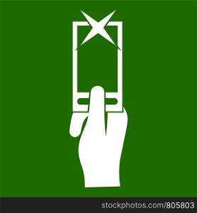 Hand photographs on smartphone icon white isolated on green background. Vector illustration. Hand photographs on smartphone icon green