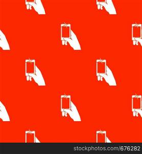 Hand taking pictures on cell phone pattern repeat seamless in orange color for any design. Vector geometric illustration. Hand taking pictures on cell phone pattern seamless
