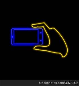 Hand with smartphone making photo neon sign. Bright glowing symbol on a black background. Neon style icon.