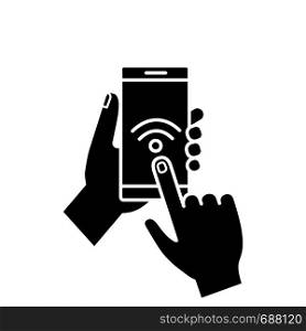 Hands holding NFC smartphone glyph icon. NFC phone. Near field communication. Mobile phone contactless payment. Wifi connection. Silhouette symbol. Negative space. Vector isolated illustration. Hands holding NFC smartphone glyph icon