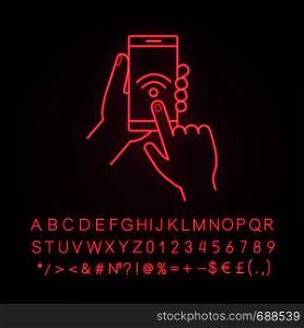 Hands holding NFC smartphone neon light icon. NFC phone. Near field communication. Mobile phone contactless payment. Glowing sign with alphabet, numbers and symbols. Vector isolated illustration. Hands holding NFC smartphone neon light icon