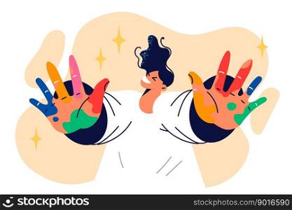 Happy boy artist in adolescence shows palms smeared with multi-colored paint after classes at art school. Creative boy who wants to become artist demonstrates hands stained with watercolors . Boy artist in adolescence shows palms smeared with multi-colored paint after classes at art school