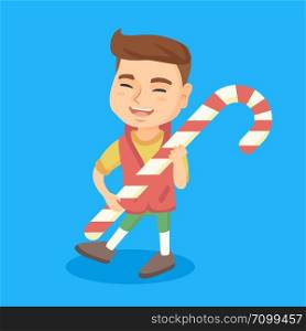 Happy caucasian little boy holding a big christmas candy cane. Full length of cheerful boy walking with a huge christmas candy cane. Vector cartoon illustration. Square layout.. Caucasian little boy holding christmas candy cane.