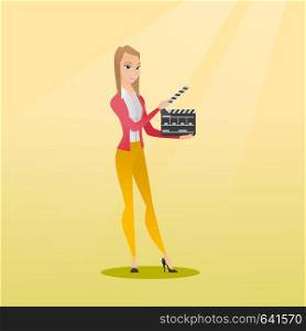Happy caucasian woman holding camera slate for the filming. Smiling woman holding an open clapperboard. Cheerful woman holding blank movie clapperboard. Vector flat design illustration. Square layout.. Smiling woman holding an open clapperboard.