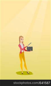 Happy caucasian woman holding camera slate for the filming. Smiling woman holding open clapperboard. Cheerful woman holding blank movie clapperboard. Vector flat design illustration. Vertical layout.. Smiling woman holding an open clapperboard.