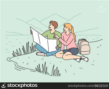 Happy couple of travelers sitting on lawn during hike in national park with lake and holding map in hands. Cheerful man and woman went on hike for adventure and new positive emotions. Happy couple of travelers sitting on lawn during hike in national park with lake and holding map