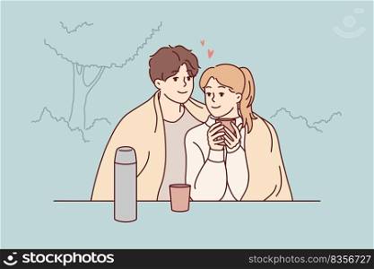 Happy couple sitting in park hugging drinking warm coffee enjoy romantic date together. Smiling loving man and woman embrace cuddling outdoors. Vector illustration.. Happy couple sitting in park drinking tea