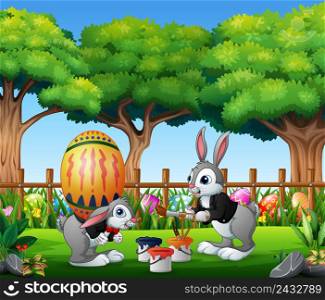 Happy easter bunnies painting and holding egg