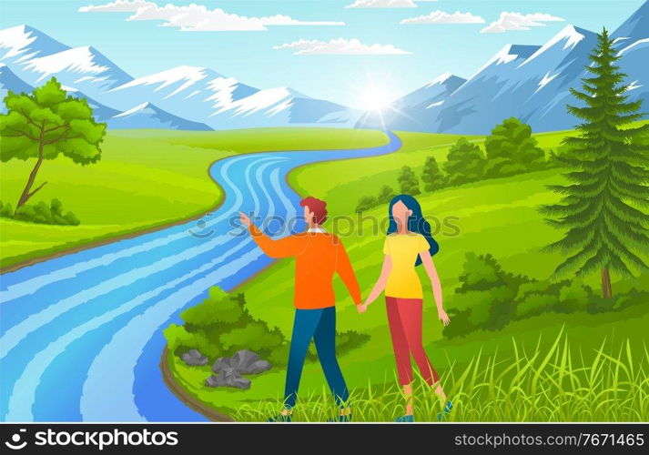 Happy in love couple holding hands and walking near river. Man show mountains to girl. People walking at nature, green grass near foot mountains. Young guy spend leisure time with girlfriend outdoors. Happy in love couple holding hands and walking near river, man show mountains to girl, summertime