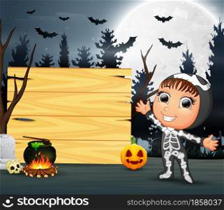 Happy kid wearing skeleton costume stand beside the wooden board