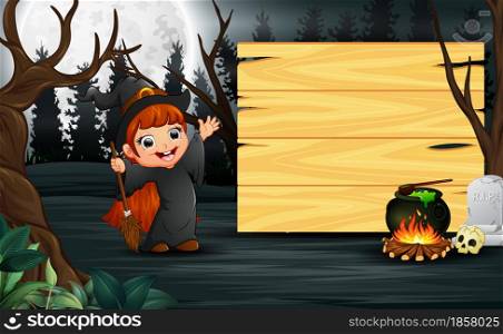 Happy kid wearing witch costume stand beside the wooden board