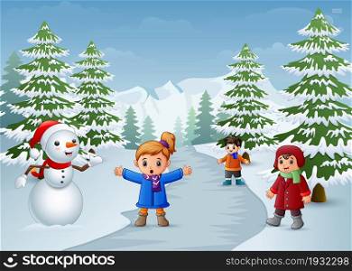 Happy kids playing with a snowman in winter