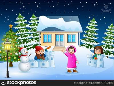 Happy kids wearing a winter clotes playing a snow in the christmas day