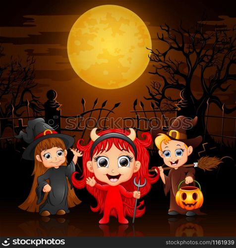 Happy little kids wearing costume halloween in graveyard