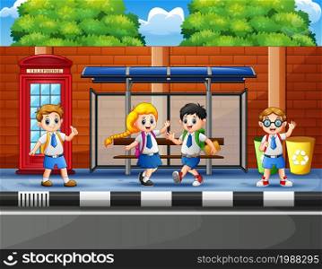Happy school children at the bus stop