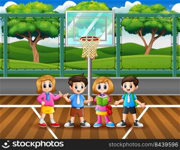 Happy school children in the basketball court 