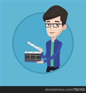 Happy smiling caucasian man holding an open clapperboard for the filming. Cheerful man holding blank movie clapperboard. Vector flat design illustration in the circle isolated on background.. Smiling man holding an open clapperboard.