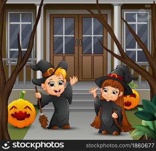 Happy witch couple standing in front of the house