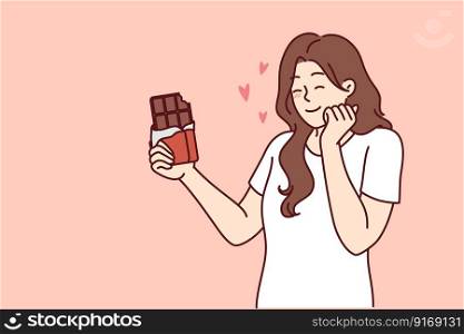 Happy woman enjoying taste of dark chocolate using sweet dessert for snacking and quickly removing hunger. concept of taking milk chocolate with sugar content to fight diabetes and increase insulin . Happy woman enjoying taste of dark chocolate using sweet dessert for snacking and removing hunger