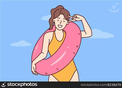 Happy woman in swimsuit for sunbathing and swimming in ocean rejoices in long-awaited summer vacation and holds lifebuoy. Girl tourist in bathing suit for beach or pool is resting on tropical island. Happy woman in swimsuit for sunbathing and swimming in ocean rejoices summer vacation
