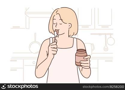 Happy woman stands in kitchen with jar of chocolate paste or peanut butter and licks spoon satisfying hunger with junk food. Positive girl eats high-calorie peanut butter after long diet. Happy woman stands in kitchen with jar of chocolate paste or peanut butter and licks spoon