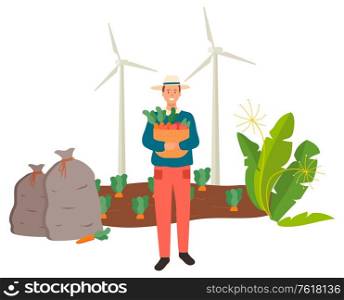 Harvesting season vector, carrots plantation flat style farmer wearing hat protecting from sun. Wind turbines renewable energy of nature. Harvest man. Farming Man Carrying Carrots on Basket Vector