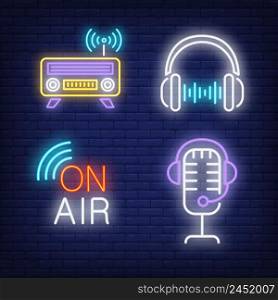 Headphones, radio and microphone neon signs set. Radio, entertainment design. Night bright neon sign, colorful billboard, light banner. Vector illustration in neon style.