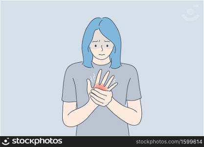 Health, care, medicine, pain, trauma concept. Young unhappy woman girl cartoon character holding massaging painful injured hand. Arthritis medical desease and rheumatism or inflammation of joints.. Health, care, medicine, pain, trauma concept