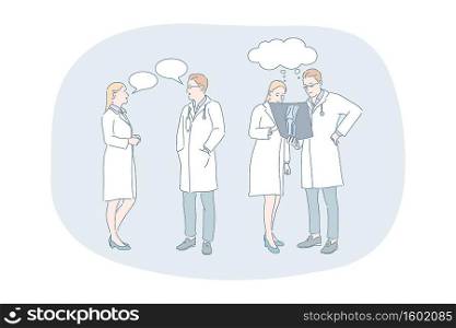 Healthcare, medicine, medicare, doctors communication and discussion concept. Young woman and man doctors in white medical uniform standing and having discussion about patients injury together. Healthcare, medicine, medicare, doctors communication and discussion concept