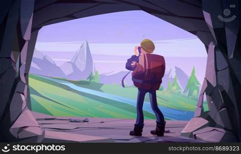 Hiker man taking photo of mountain landscape in cave entrance. Vector cartoon illustration of tourist photographer with camera in stone cavern and scene with rocks, trees and river. Hiker man taking photo of mountain landscape