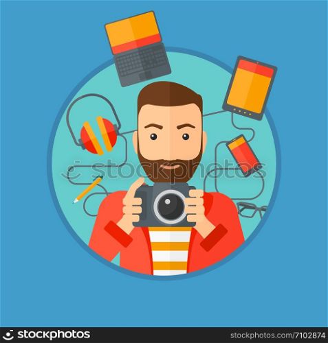 Hipster man with the beard taking photo with digital camera. Young man surrounded with gadgets. Man using many electronic gadgets. Vector flat design illustration in the circle isolated on background.. Young man surrounded with his gadgets.