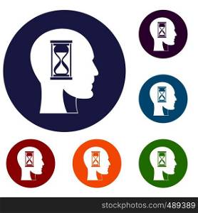 Hourglass in head icons set in flat circle red, blue and green color for web. Hourglass in head icons set