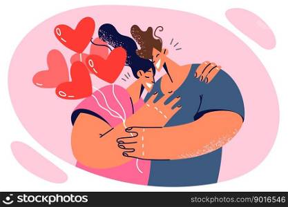 Hugging couple of man and woman in love with balloons in form of hearts celebrating Valentine Day. Romantic happy couple during date or celebrating wedding anniversaries and starting family life. Hugging couple of man and woman in love with balloons in form of hearts celebrating Valentine Day