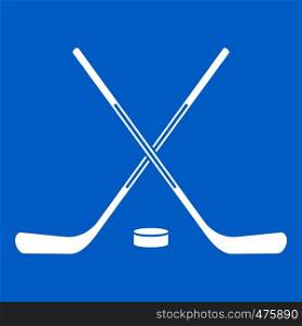 Ice hockey sticks icon white isolated on blue background vector illustration. Ice hockey sticks icon white