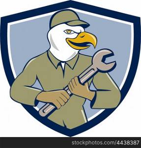Illustration of a american bald eagle mechanic holding spanner looking to the side viewed from front set inside shield crest on isolated background done in cartoon style. . American Bald Eagle Mechanic Spanner Crest Cartoon