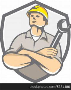 Illustration of a builder construction worker arms crossed holding wrench looking up set inside shield crest on isolated background done in retro style.. Builder Arms Crossed Wrench Shield Retro