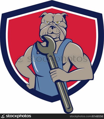 Illustration of a bulldog mechanic wearing overalls holding wrench viewed from front set inside shield crest done in cartoon style.. Bulldog Mechanic Holding Wrench Shield Cartoon