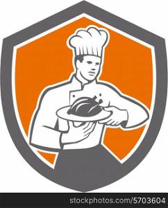 Illustration of a chef cook holding serving serve plate platter with chicken set inside shield crest on isolated background done in retro style. . Chef Cook Serving Chicken Platter Shield Retro
