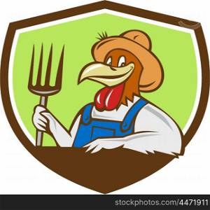 Illustration of a chicken farmer wearing overalls and hat holding pitchfork viewed from front set inside shield crest on isolated background done in cartoon style. . Chicken Farmer Pitchfork Crest Cartoon