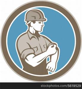 Illustration of a construction worker wearing hardhat rolling up sleeve facing side set inside circle on isolated background done in retro style.. Construction Worker Rolling Up Sleeve Circle Retro